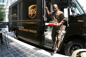 UPS guy exiting truck with box